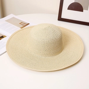 Chic beige wide brim straw sun hat with woven texture for summer beach vacation