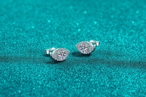 Macro shot of S925 silver stud earrings with marquise-shaped halo and moissanite stones