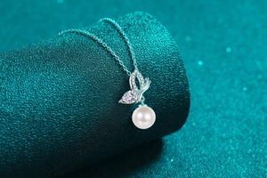 Detailed view of S925 silver butterfly pendant with moissanite and a round white pearl