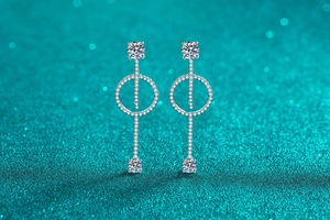 Macro view of long linear S925 sterling silver drop earrings with sparkling moissanite stones
