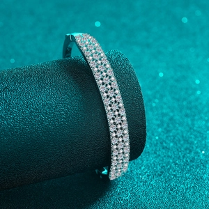Elegant S925 sterling silver bangle with pavé moissanite on a dark textured display
