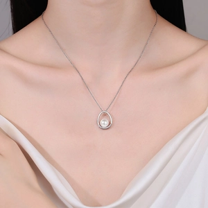 Elegant S925 silver necklace with oval pearl pendant and moissanite accents on woman