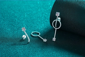 Macro detail of S925 sterling silver long drop earrings with moissanite accents