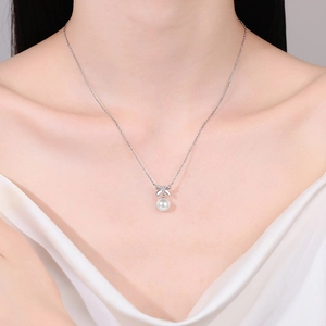 S925 sterling silver bow necklace with moissanite and pearl pendant on a model