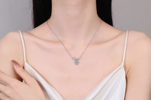 Detail shot of a polished S925 silver heart necklace with sparkling moissanite stones