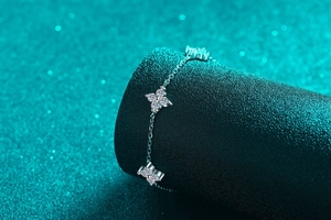 Detail view of S925 sterling silver bracelet with sparkling moissanite star charms