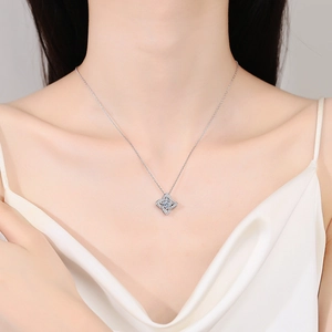 S925 sterling silver necklace with clover pendant worn by a model in soft lighting
