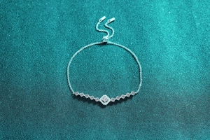 Close-up of S925 silver moissanite bracelet with adjustable square slider chain