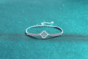 Macro detail of S925 silver four-leaf clover bracelet with sparkling pavé moissanite stones