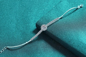 Detail of silver moissanite bracelet with round cut stones and lobster clasp closure