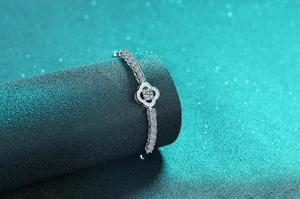 Macro shot of S925 silver four-leaf clover bracelet with sparkling moissanite pavé stones