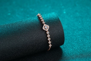 Macro detail of rose gold square cluster bracelet with geometric zircon links