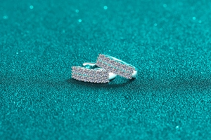 Detailed macro view of S925 sterling silver earrings with double rows of pavé moissanite