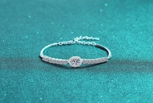 Macro detail of S925 sterling silver bracelet with oval halo blue moissanite centerpiece