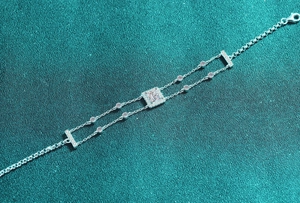 Detail of S925 silver double chain bracelet with square moissanite and halo setting