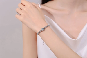 Macro detail of S925 silver tennis bracelet with moissanite center stone and pavé setting