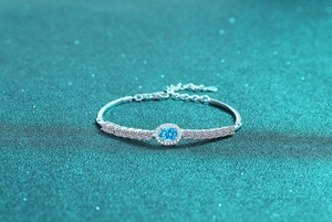 Close-up of S925 sterling silver bracelet with blue oval stone and sparkling pavé diamonds