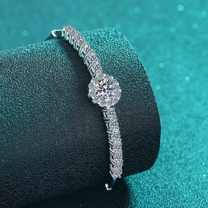 Sparkling S925 sterling silver moissanite bracelet with flower design on a green pedestal