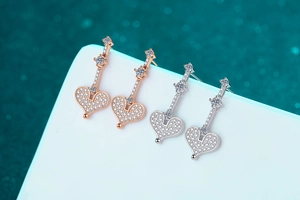 Detail of S925 silver heart drop earrings in champagne gold and silver with moissanite