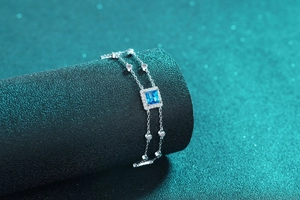 Detailed close-up of S925 silver double-strand bracelet with square blue moissanite stone