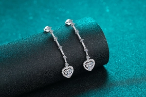 Macro shot of S925 silver long heart earrings featuring halo-set moissanite tassels