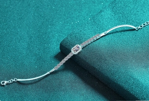 Macro detail of S925 silver bracelet featuring pink moissanite stone and side zircons