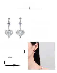 Detail showing multi-layer platinum-plated heart earrings with moissanite pavé setting