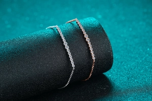 Detailed close-up of Moissanite tennis bracelets in silver and rose gold finishes