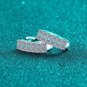 Elegant S925 sterling silver hoop earrings with double row moissanite on blue background