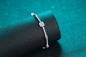 Macro shot of S925 silver moissanite bracelet with square emerald cut stone on display
