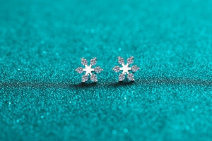 Macro shot of S925 sterling silver snowflake earrings with sparkling moissanite stones