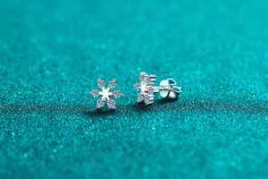Macro shot of S925 sterling silver snowflake earrings with moissanite inlays