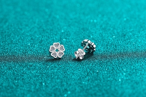 Detailed macro view of S925 silver flower stud earrings with sparkling moissanite petals