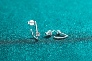 Close-up of minimalist S925 sterling silver bar earrings with round moissanite studs