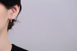 Close-up of minimalist S925 sterling silver ear studs with irregular lines on ear