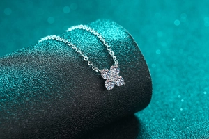 Close-up of S925 sterling silver necklace with sparkling four-stone moissanite petal pendant