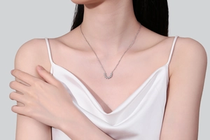 Close-up of minimalist S925 sterling silver U-shaped moissanite pendant on a model