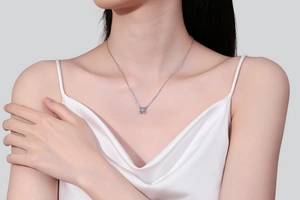Close-up of S925 silver petal pendant necklace with moissanite on a model