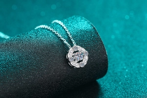 Detail of S925 sterling silver necklace with a hollow petal pendant and moissanite stone