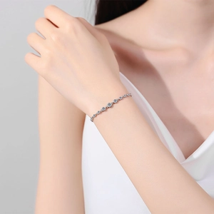 Elegant S925 sterling silver thin bracelet with circular moissanite stones on a wrist