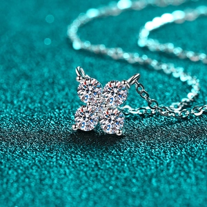S925 sterling silver moissanite necklace featuring a four-petal flower pendant on green glitter