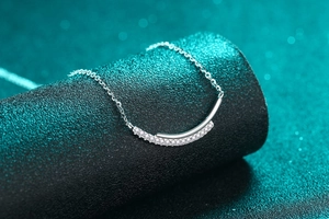 Dettaglio collana in argento S925 con pendente a barra sorridente e moissanite lucida