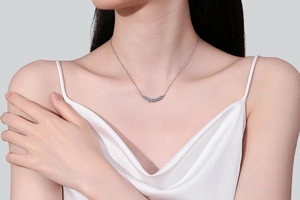 Close-up of S925 sterling silver necklace featuring a curved row of seven brilliant moissanite