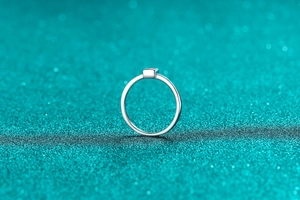 Macro shot of minimalist S925 sterling silver ring with small square moissanite stone