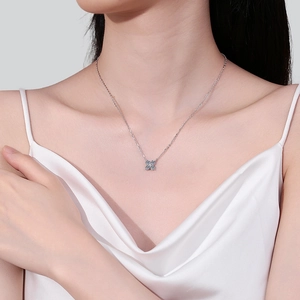 Elegant S925 sterling silver moissanite necklace with four-petal flower pendant on model
