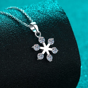 S925 sterling silver snowflake pendant necklace with moissanite on a blue glitter background