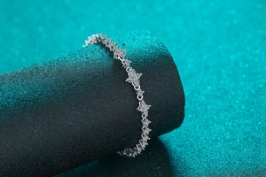 Detailed view of S925 sterling silver moissanite bracelet with floral nodes on a black stand