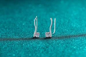 Macro detail of S925 sterling silver moissanite earrings with elegant S-curve design