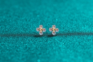 Dettaglio macro di orecchini a stella in argento S925 con finitura in oro champagne e pietre