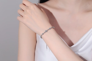 Close-up of S925 sterling silver moissanite bracelet with star links and blue crystals